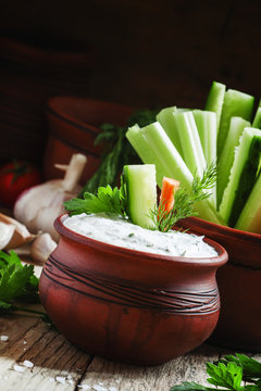 Fresh sticks carrots, celery, cucumber and white sauce with herb