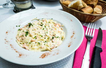 tasty pasta with salmon on a the table