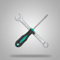 Crossed wrench and screwdriver on gray background like icon