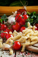 Dry Italian pasta spiraline with cherry tomatoes, parsley, garli