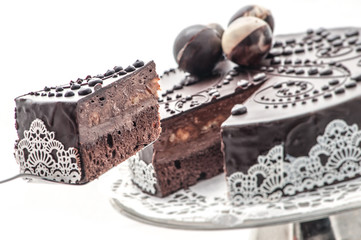 Exclusive chocolate cake with lace and chocolate decoration, patisserie, photography for shop, sweet dessert

