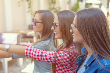 Young girls having fun at sunny day in cafe