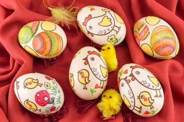 Decorated Easter eggs on red silk