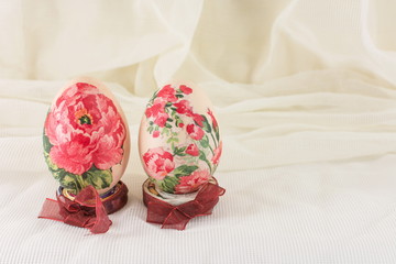 Decoupage decorated Easter eggs against silky background