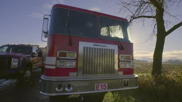 Two fire trucks wait at the ready