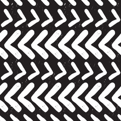 Modern and trendy abstract white hand drawn chevron texture pattern on black background