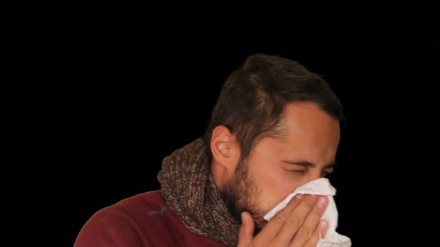  A cold man sneezes