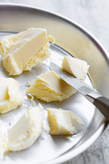 Pieces of fresh butter in a small aluminium pan