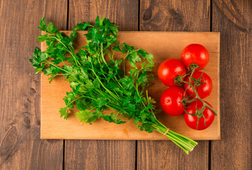 Fettuccine pasta with shrimp tomatoes and herbs. wooden background