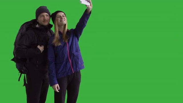 Hikers couple taking a selfie - green screen. Prores 422HQ 4K UHD 60FPS slow motion shot. Shot with Blackmagic URSA Mini