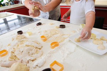 Obraz na płótnie Canvas Hands of child knead dough