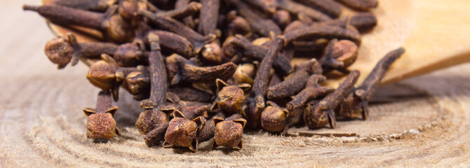 Cloves on a wood board.