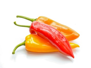 colored peppers over white background