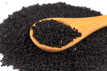 Heap of black sesame on wooden spoon