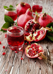 Fresh pomegranates and juice, selective focus