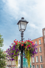 Fototapeta na wymiar Old-fashioned street lamp against the buildings. Dublin, Ireland.