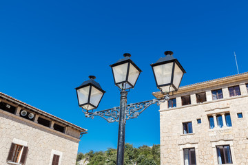 Fototapeta na wymiar Old-fashioned street lamp against the building. Lluc Monastery. Majorca. Spain.