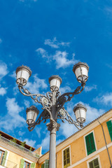 Fototapeta na wymiar Old-fashioned street lamp against the sky. Palma de Mallorca. Majorca. Spain.