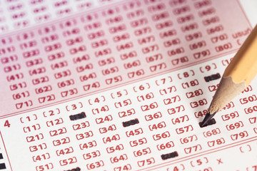  Marking number on lottery ticket with pencil.