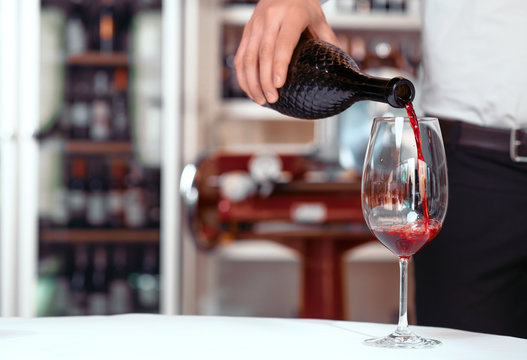 Sommelier Pouring Wine Into Wineglasses 