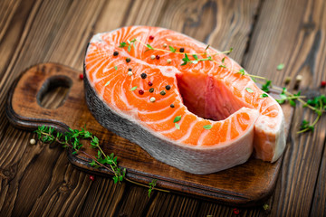raw salmon fish steak on wooden rustic background