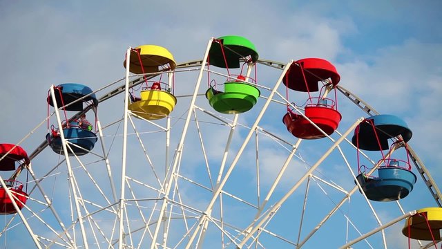 Colorful cabins of ferris wheel in amusement park 