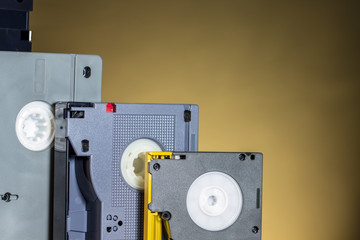 Digital video tapes of Broadcast level of different formats and sizes, on orange background