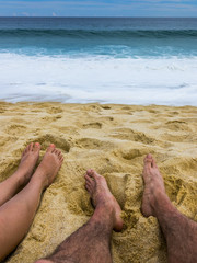 Couples Feet in the Sand Together at Beach