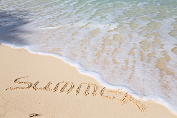 Word SUMMER on beach - vacation concept background