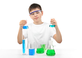 Clever little boy doing a chemical experiments, isolated on white