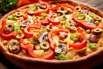 Delicious pizza with vegetables and meat, close-up
