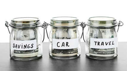 Three jars for different needs full of banknotes