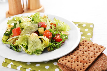 Tasty salmon salad on light wooden background