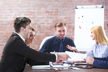 Young business people discussing a new project at the meeting in a conference room