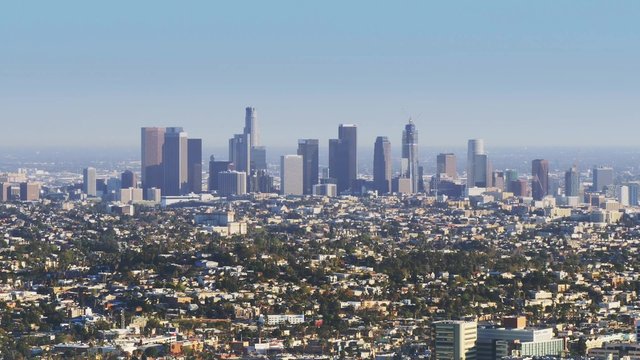 A daytime establishing shot of the Los Angeles skyline.  	