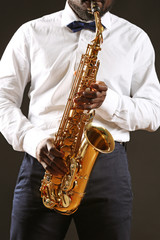 Fototapeta na wymiar African American jazz musician playing the saxophone, closeup
