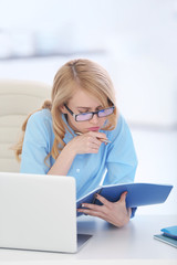 Tired woman at the laptop in office