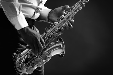 African American jazz musician playing the saxophone, closeup - obrazy, fototapety, plakaty