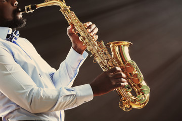 Obraz na płótnie Canvas African American jazz musician playing the saxophone, closeup