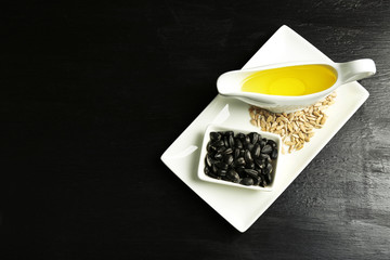 Sunflower seeds with oil on wooden table