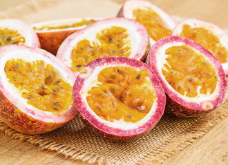 Half cut passion fruit isolated on sackcloth and wooden backgrou