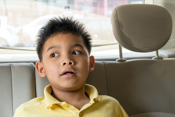 Asian boy Smiling on back seat