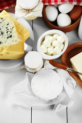 Set of fresh dairy products on white wooden table