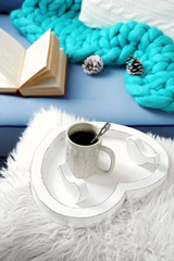 Cup of hot drink in living room. Comfortable winter weekend or holidays at home