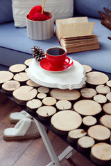 Cup of hot drink in living room. Comfortable winter weekend or holidays at home