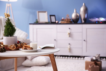 Small decorated Christmas tree on the table in the room, close up