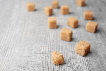 Pile of brown sugar cubes and stevia isolated on white background