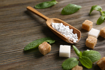 Sugar cubes and stevia  on wooden background