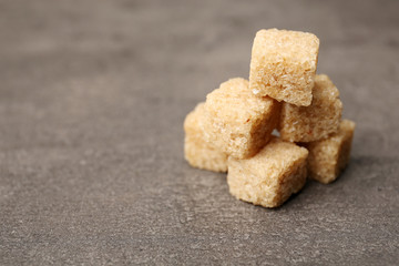 Pile of brown sugar cubes on the table
