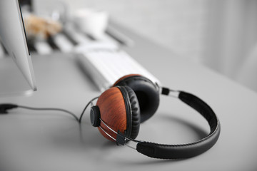 Obraz na płótnie Canvas Headphones on gray table against defocused background